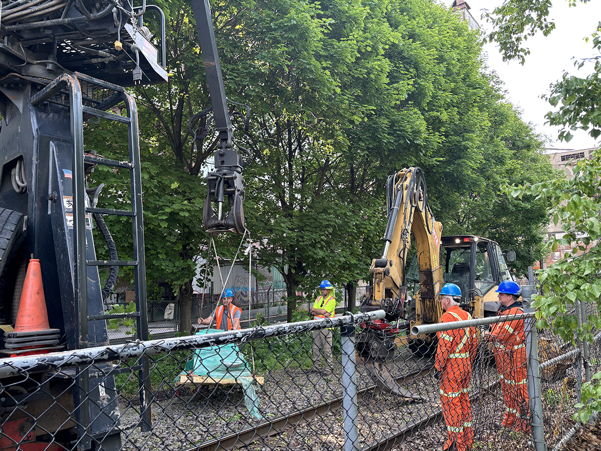 Employees installing the rail lubricators
