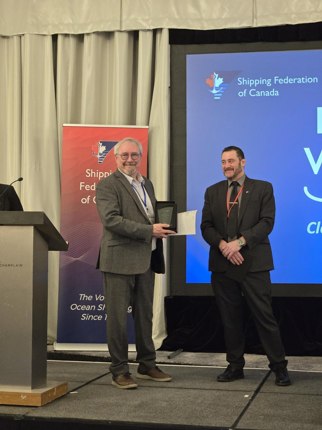 Jean-François Belzile is presented an award at Mariners workshop